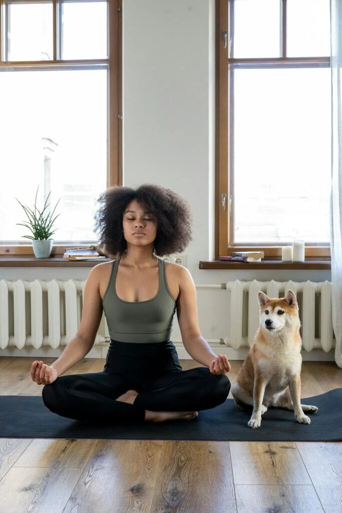 A woman meditates, breathing in quality air indoors.